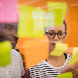 Business executives reading sticky notes